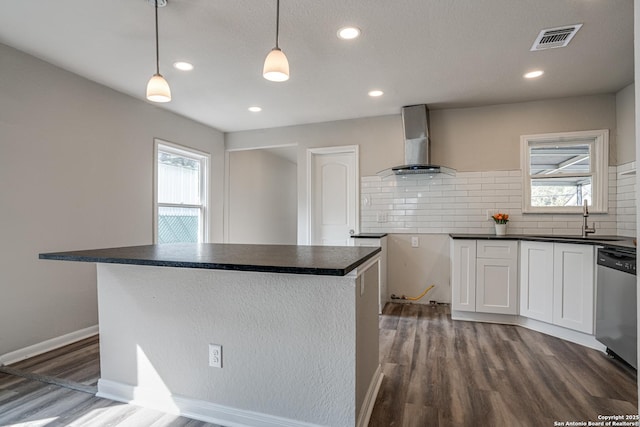 2411 W Huisache Ave, San Antonio, TX 78228 - kitchen with wall chimney exhaust hood, stainless steel dishwasher, dark countertops, a sink, and recessed lighting