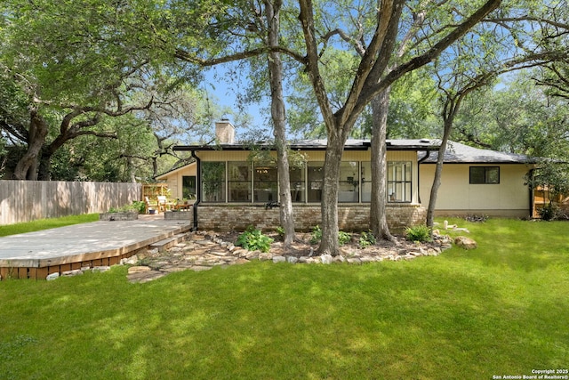500 Skyforest, Hollywood Park, TX 78232 - rear view of house with a chimney, a wooden deck, and a sunroom