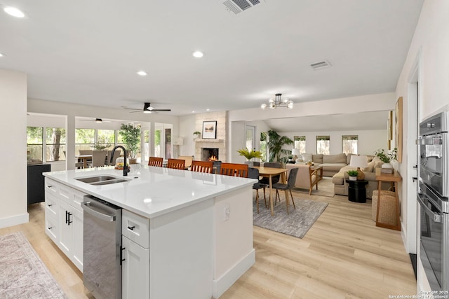 500 Skyforest, Hollywood Park, TX 78232 - kitchen featuring a sink, open floor plan, stainless steel appliances, a fireplace, and recessed lighting