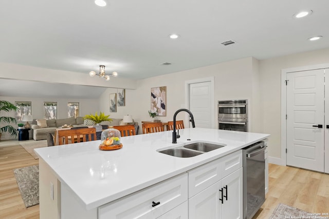 500 Skyforest, Hollywood Park, TX 78232 - kitchen with a sink, stainless steel appliances, a center island with sink, light wood-type flooring, and recessed lighting
