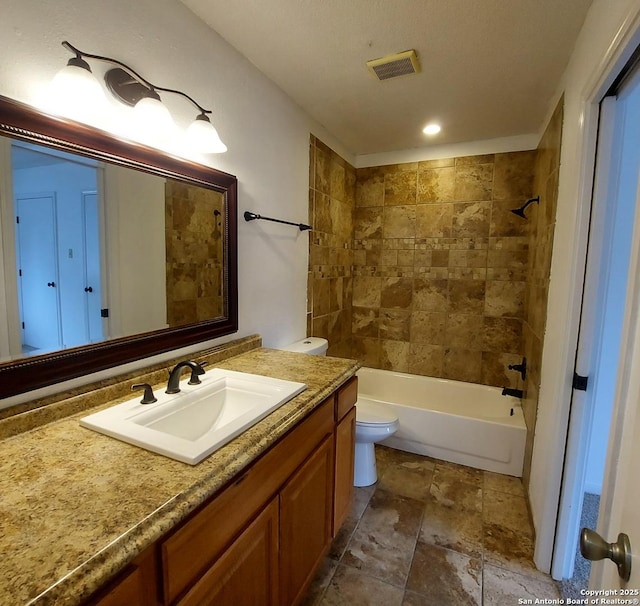 3730 Candlestone, San Antonio, TX 78244 - full bath with toilet, stone tile floors, vanity, washtub / shower combination, and recessed lighting