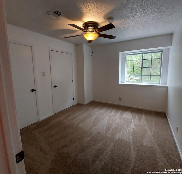 3730 Candlestone, San Antonio, TX 78244 - unfurnished bedroom featuring light colored carpet, a textured ceiling, a ceiling fan, and baseboards