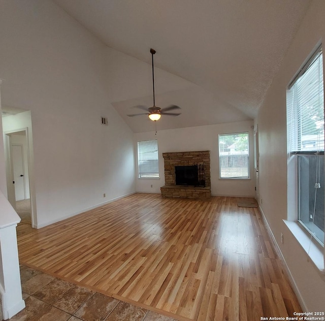 3730 Candlestone, San Antonio, TX 78244 - unfurnished living room with a fireplace, plenty of natural light, light wood-style floors, high vaulted ceiling, and ceiling fan