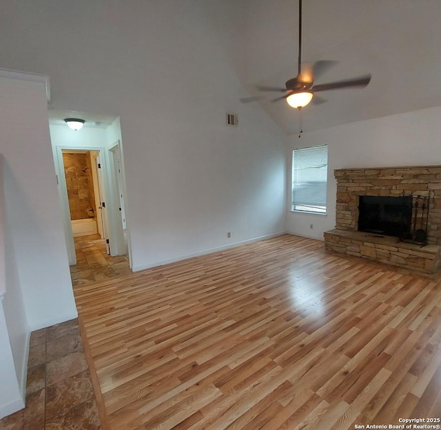 3730 Candlestone, San Antonio, TX 78244 - unfurnished living room featuring a ceiling fan, light wood-style floors, and a fireplace