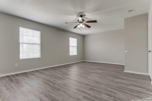 16311 Kentucky Rdg, Selma, TX 78154 - unfurnished room with a ceiling fan, wood finished floors, a smoke detector, baseboards, and a textured ceiling