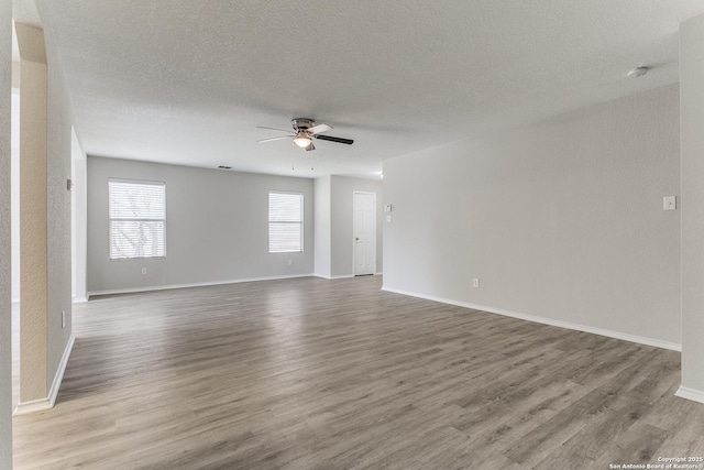 16311 Kentucky Rdg, Selma, TX 78154 - unfurnished room with ceiling fan, wood finished floors, a textured ceiling, baseboards, and a smoke detector