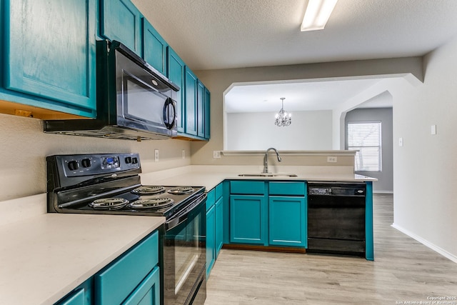 16311 Kentucky Rdg, Selma, TX 78154 - kitchen featuring black appliances, a sink, a chandelier, a peninsula, and light countertops