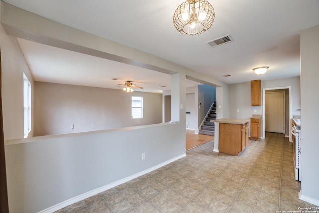 9843 Barhill Bay, San Antonio, TX 78245 - kitchen with light countertops, a kitchen island, open floor plan, and baseboards