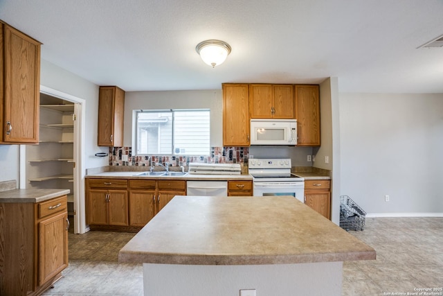 9843 Barhill Bay, San Antonio, TX 78245 - kitchen with white appliances, a sink, and brown cabinetry