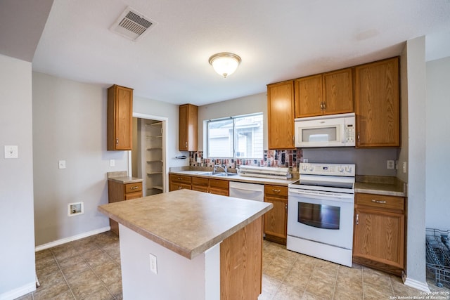 9843 Barhill Bay, San Antonio, TX 78245 - kitchen featuring white appliances, a sink, brown cabinets, and light countertops