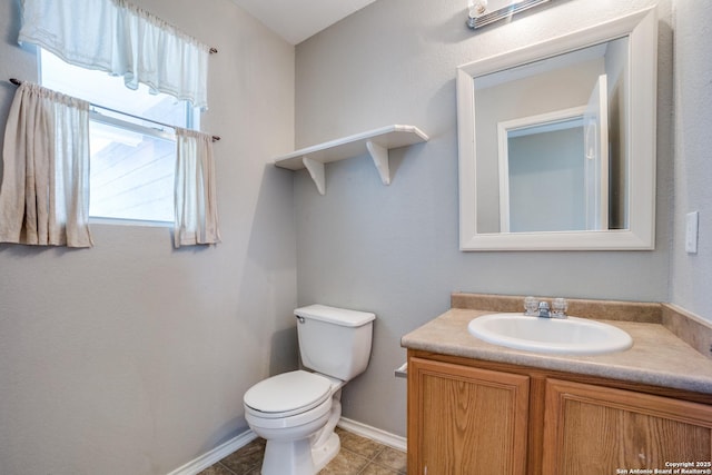 9843 Barhill Bay, San Antonio, TX 78245 - bathroom with toilet, vanity, baseboards, and tile patterned flooring