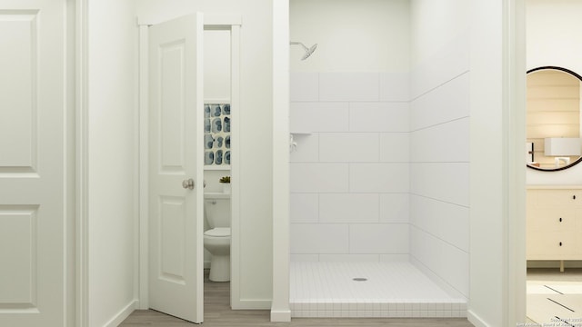 426 Kayden Ct, Marion, TX 78124 - bathroom with a stall shower, toilet, baseboards, and wood finished floors