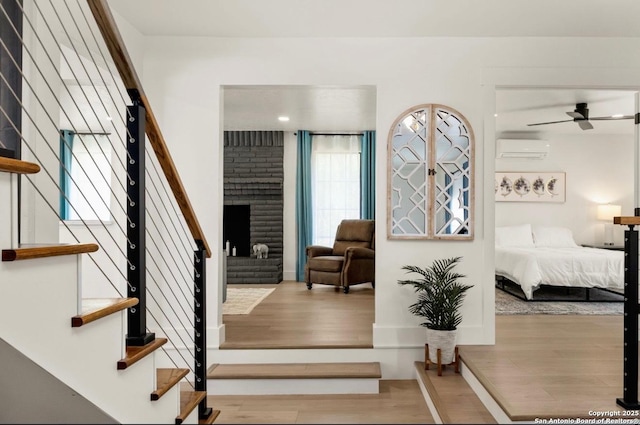 3719 Summer Breeze, San Antonio, TX 78253 - stairway with a wall mounted air conditioner, wood finished floors, and a fireplace
