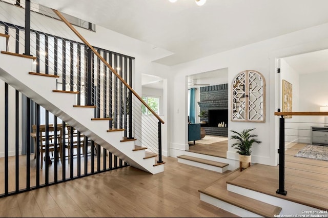 3719 Summer Breeze, San Antonio, TX 78253 - entryway featuring wood finished floors, stairs, a fireplace, and baseboards