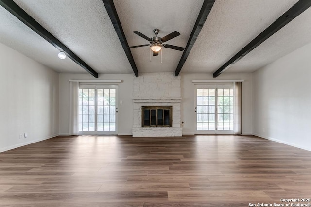 6419 Ridge Tree, San Antonio, TX 78233 - unfurnished living room featuring plenty of natural light, a ceiling fan, a textured ceiling, beamed ceiling, and wood finished floors