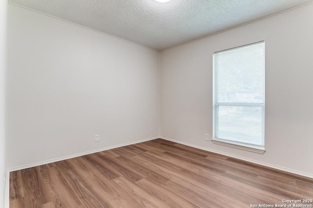 6419 Ridge Tree, San Antonio, TX 78233 - spare room with light wood-type flooring, a textured ceiling, and baseboards