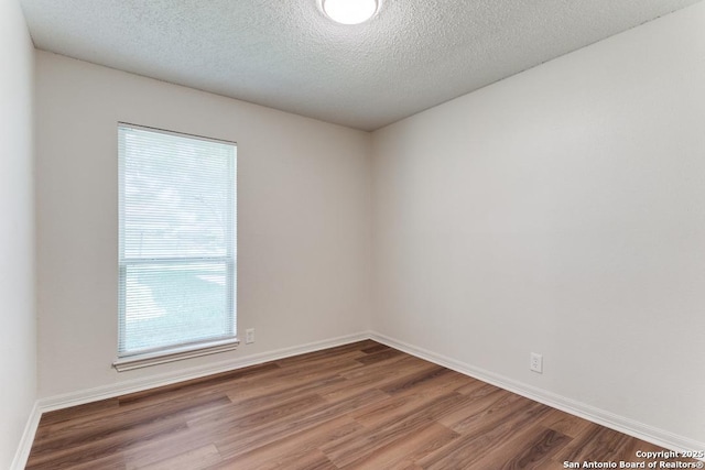 6419 Ridge Tree, San Antonio, TX 78233 - empty room featuring wood finished floors, a textured ceiling, and baseboards