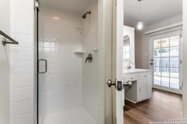 6419 Ridge Tree, San Antonio, TX 78233 - bathroom with a shower stall, vanity, and wood finished floors