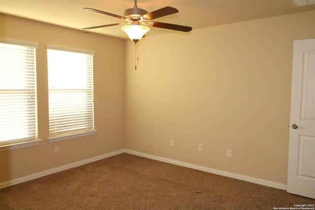 9118 Hogarten, Converse, TX 78109 - unfurnished room featuring healthy amount of natural light, ceiling fan, carpet flooring, and baseboards