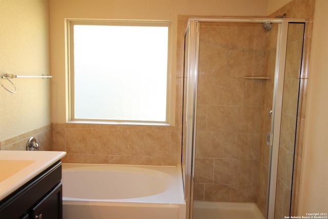9118 Hogarten, Converse, TX 78109 - bathroom featuring a stall shower, a garden tub, and vanity