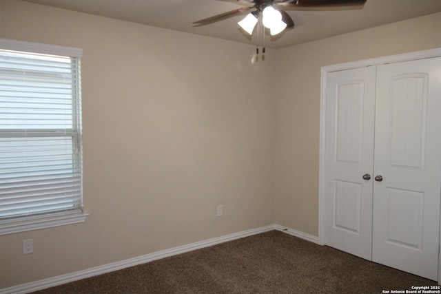 9118 Hogarten, Converse, TX 78109 - spare room featuring a ceiling fan, dark colored carpet, and baseboards