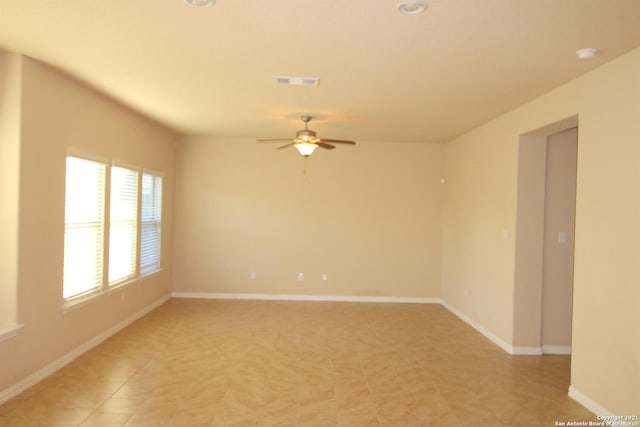 9118 Hogarten, Converse, TX 78109 - empty room featuring a ceiling fan, baseboards, and light tile patterned flooring