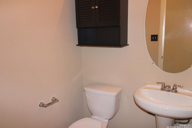 9118 Hogarten, Converse, TX 78109 - half bathroom with toilet and a sink
