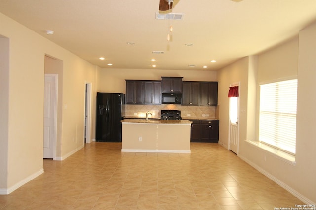 9118 Hogarten, Converse, TX 78109 - kitchen with black appliances, backsplash, an island with sink, light tile patterned floors, and recessed lighting
