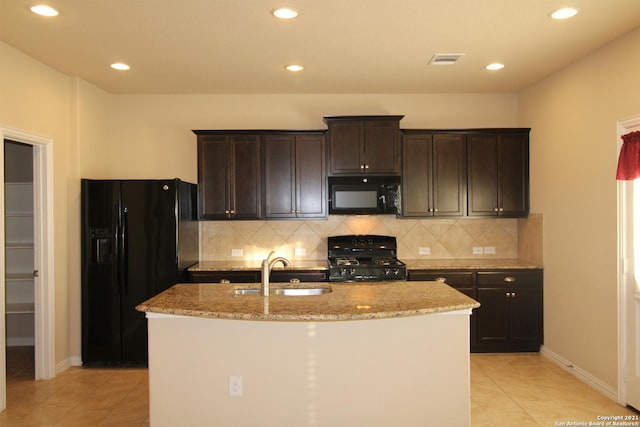 9118 Hogarten, Converse, TX 78109 - kitchen with black appliances, a sink, light tile patterned floors, an island with sink, and light stone counters