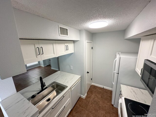 11311 Sir Winston Unit 607, San Antonio, TX 78216 - kitchen featuring electric range, a sink, a textured ceiling, a textured wall, and dishwasher