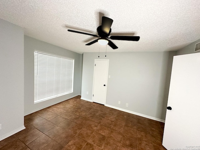 11311 Sir Winston Unit 607, San Antonio, TX 78216 - empty room with a textured ceiling, a ceiling fan, and baseboards