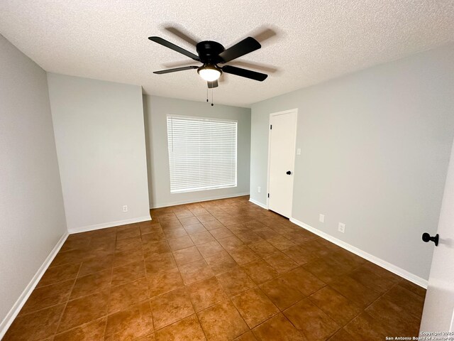 11311 Sir Winston Unit 607, San Antonio, TX 78216 - empty room featuring ceiling fan, a textured ceiling, tile patterned floors, and baseboards