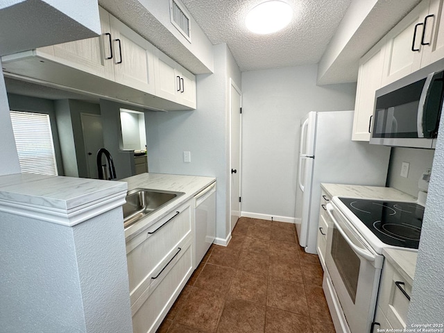 11311 Sir Winston Unit 607, San Antonio, TX 78216 - kitchen featuring white appliances, white cabinets, a textured ceiling, dark tile patterned flooring, and a sink