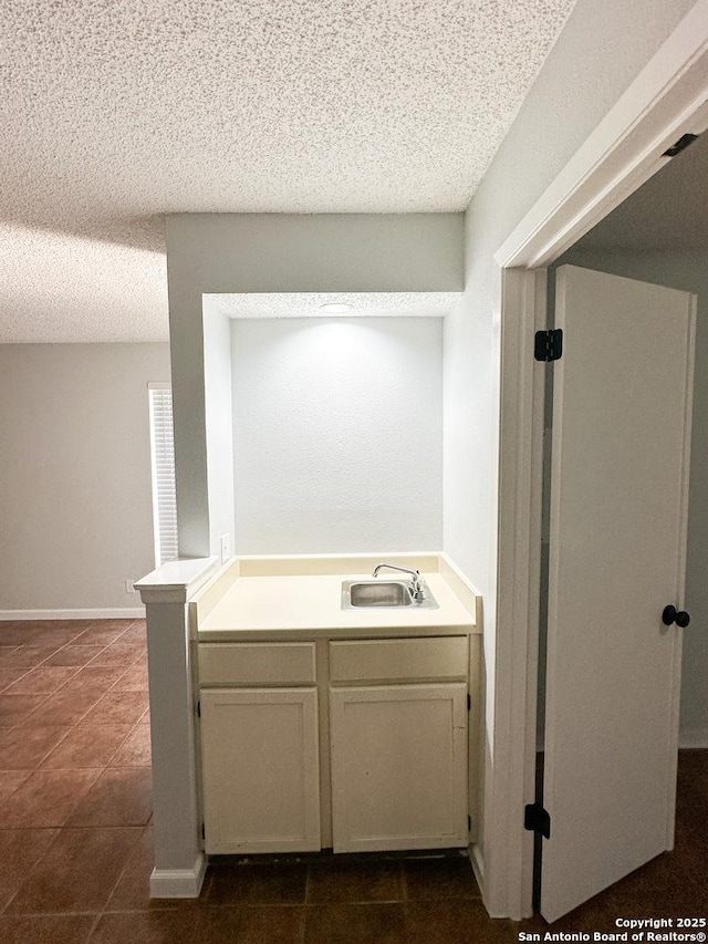 11311 Sir Winston Unit 607, San Antonio, TX 78216 - bathroom featuring a sink, a textured ceiling, and tile patterned floors