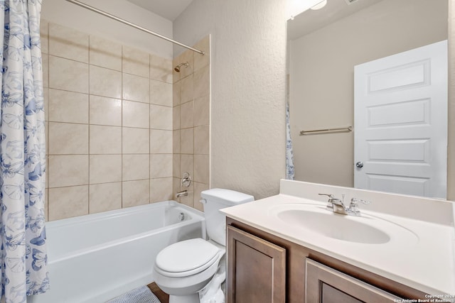 2429 Marty Way, Seguin, TX 78155 - full bathroom with a textured wall, shower / bath combo, toilet, and vanity