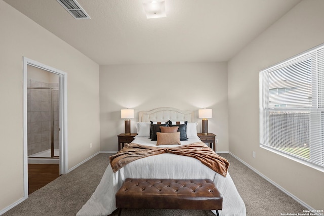 2429 Marty Way, Seguin, TX 78155 - carpeted bedroom with multiple windows, baseboards, and ensuite bathroom