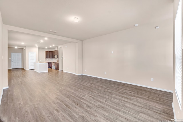 2429 Marty Way, Seguin, TX 78155 - unfurnished living room with light wood-style floors, baseboards, and recessed lighting