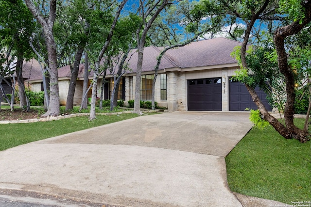 9215 Standing Crk, San Antonio, TX 78230 - view of front facade featuring an attached garage, driveway, a shingled roof, and brick siding