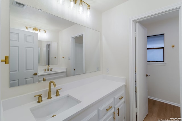 9215 Standing Crk, San Antonio, TX 78230 - bathroom with wood finished floors, vanity, and baseboards
