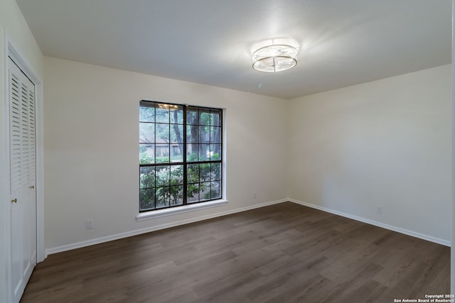 9215 Standing Crk, San Antonio, TX 78230 - unfurnished bedroom featuring dark wood finished floors, baseboards, and a closet
