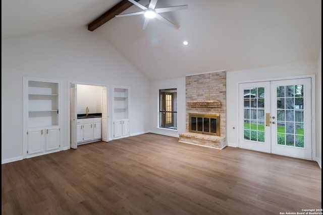 9215 Standing Crk, San Antonio, TX 78230 - unfurnished living room featuring beam ceiling, a ceiling fan, french doors, high vaulted ceiling, and a sink