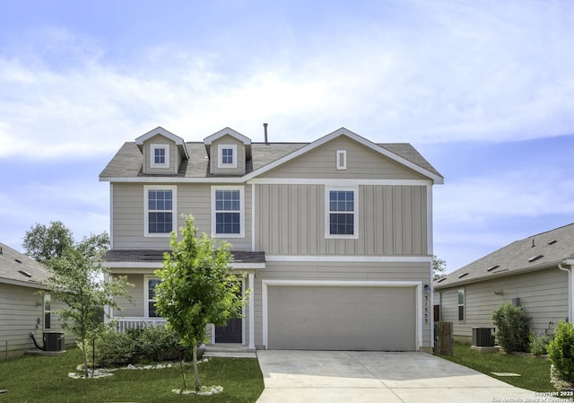 31553 Acacia Vis, Bulverde, TX 78163 - view of front facade with driveway, a garage, central AC, board and batten siding, and a front lawn