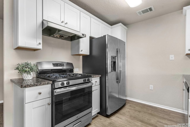 31553 Acacia Vis, Bulverde, TX 78163 - kitchen with under cabinet range hood, stainless steel appliances, baseboards, light wood finished floors, and white cabinets