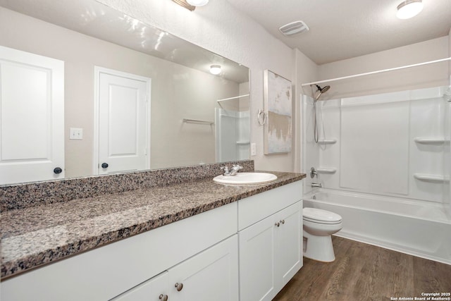 31553 Acacia Vis, Bulverde, TX 78163 - full bath featuring wood finished floors, toilet, vanity, and washtub / shower combination