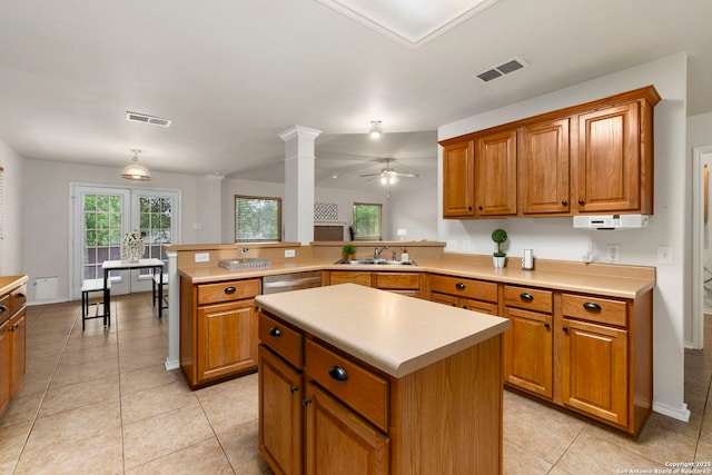 15311 Spring Rock, San Antonio, TX 78247 - kitchen featuring a peninsula, a sink, light countertops, stainless steel dishwasher, and brown cabinetry