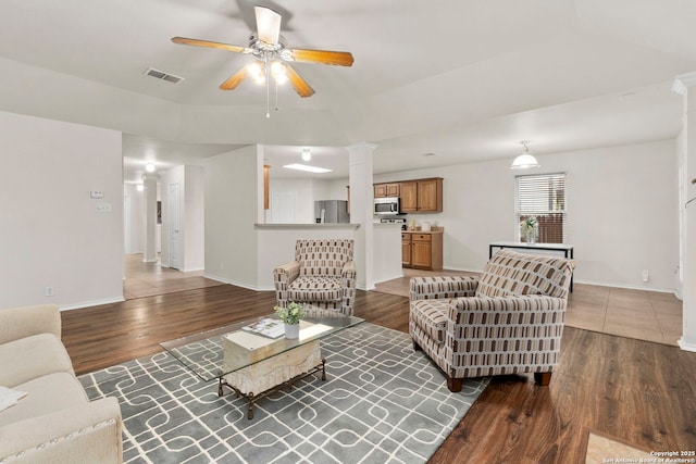 15311 Spring Rock, San Antonio, TX 78247 - living area featuring ornate columns, a ceiling fan, wood finished floors, and baseboards