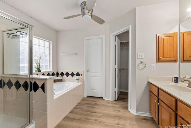 15311 Spring Rock, San Antonio, TX 78247 - full bathroom featuring vanity, a shower stall, a bath, a ceiling fan, and wood finished floors
