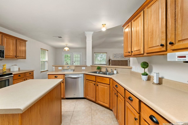 15311 Spring Rock, San Antonio, TX 78247 - kitchen with appliances with stainless steel finishes, a sink, light countertops, a peninsula, and brown cabinets