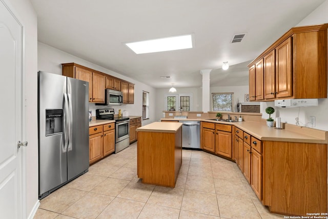 15311 Spring Rock, San Antonio, TX 78247 - kitchen with appliances with stainless steel finishes, a sink, a peninsula, light countertops, and light tile patterned floors
