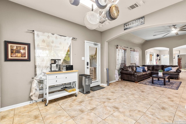 21742 Thunder Basin, San Antonio, TX 78261 - tiled living room with arched walkways, vaulted ceiling, baseboards, and a ceiling fan